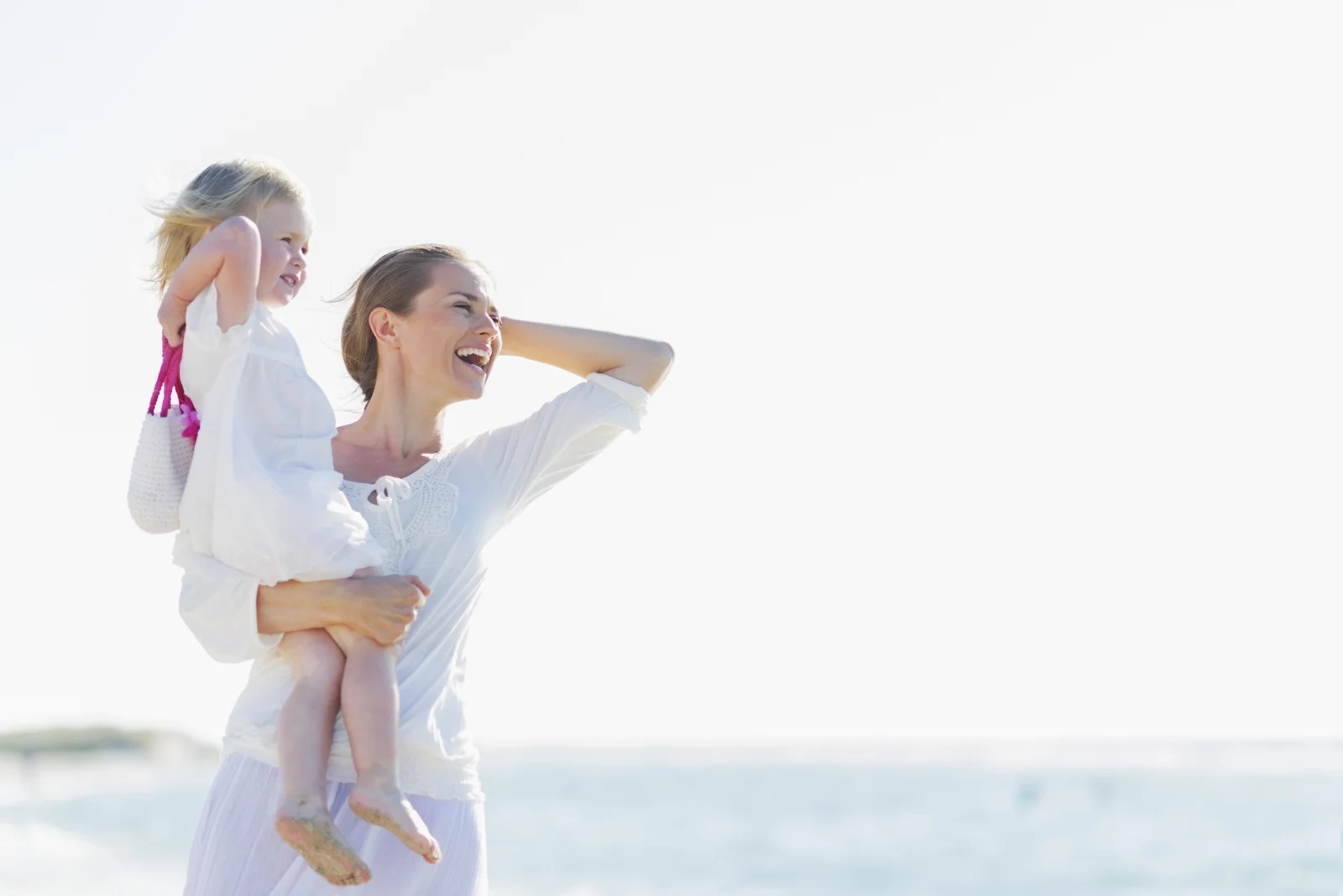 Mother and daughter smiling together in daylight